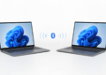 Two Windows 11 laptops connected by a Bluetooth PAN link on a white background.